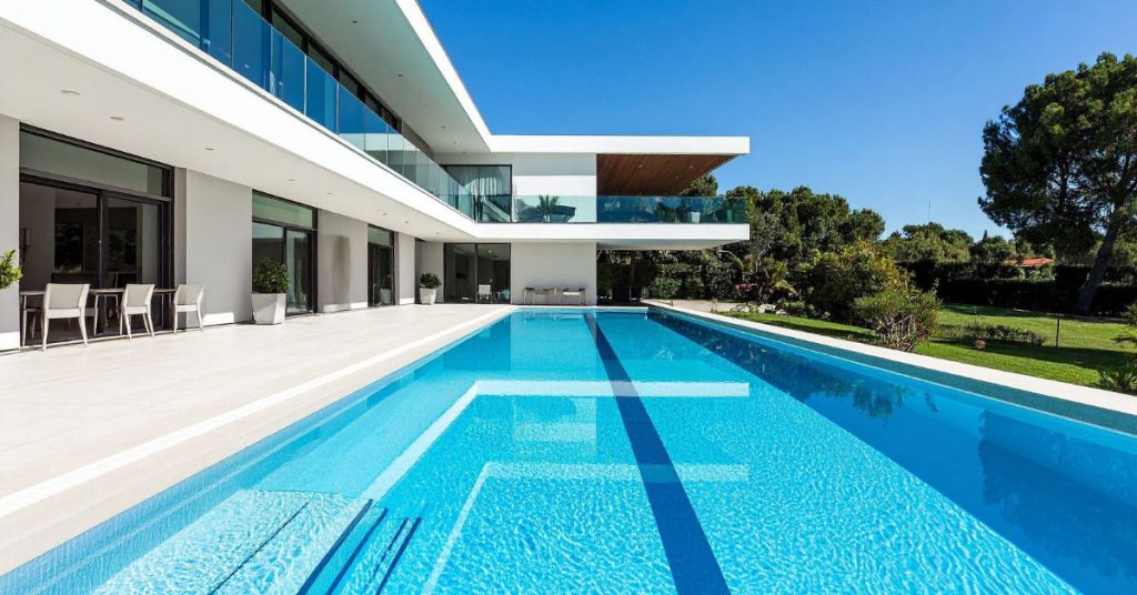 Modern luxury backyard swimming pool with clean lines and contemporary home